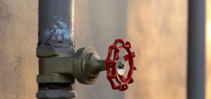Red handwheel valve on a water pipe
